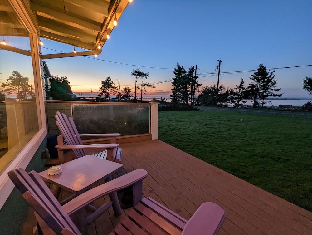 Chairs overlooking the water at sunset from our romantic Sequim Lodging