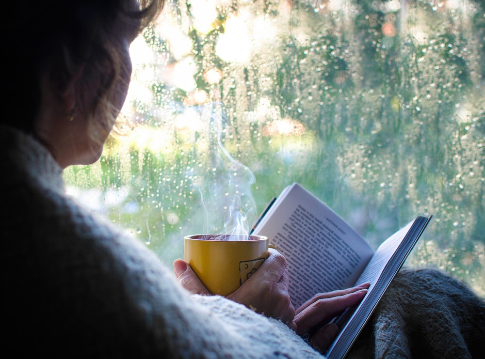 Woman reading a book and enjoying one of the best rainy day things to do in Sequim